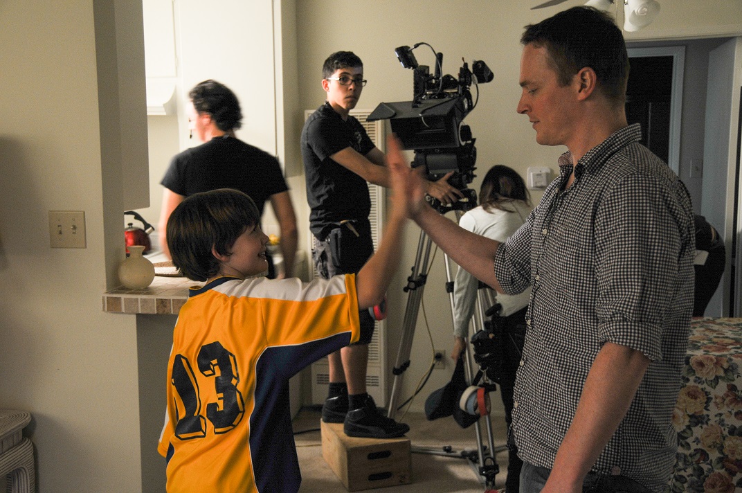 Director Simon Savelyev high fives Talton Browning on the set of Googly Eyes (Photo courtesy of Simon Savelyev)